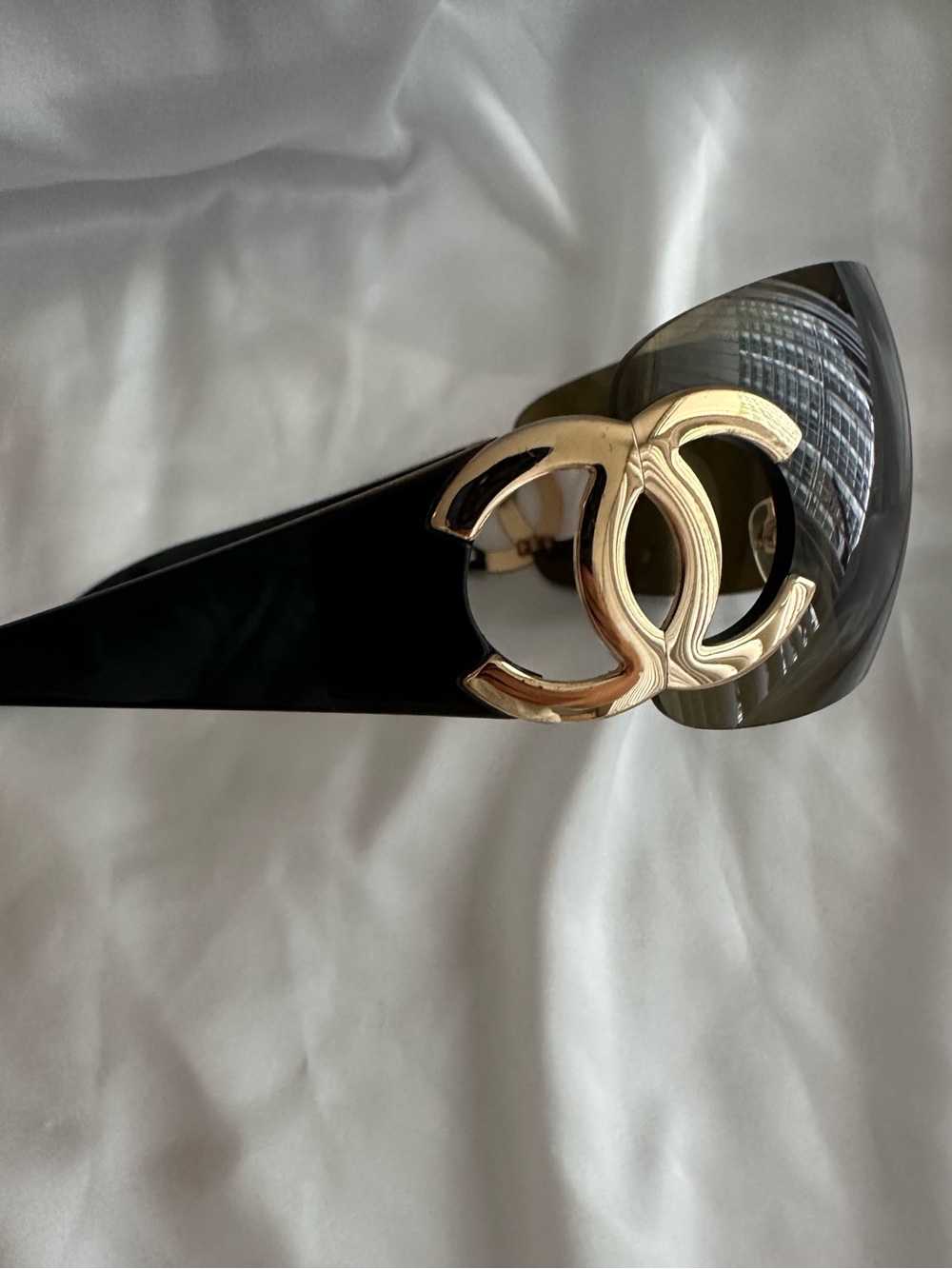 CHANEL Black Patent Slip-On Mules with Gold CC Emblem